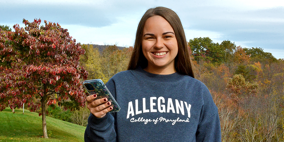 Student holding her phone