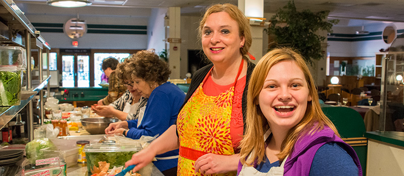 Students in a cooking class looking at the camera