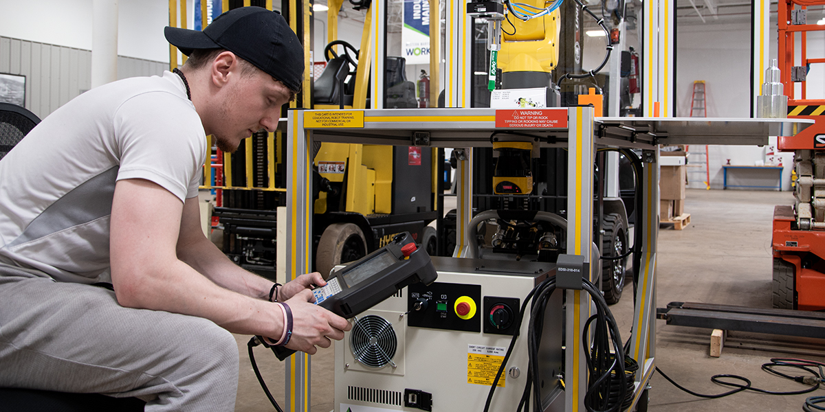 Student working on metal machine