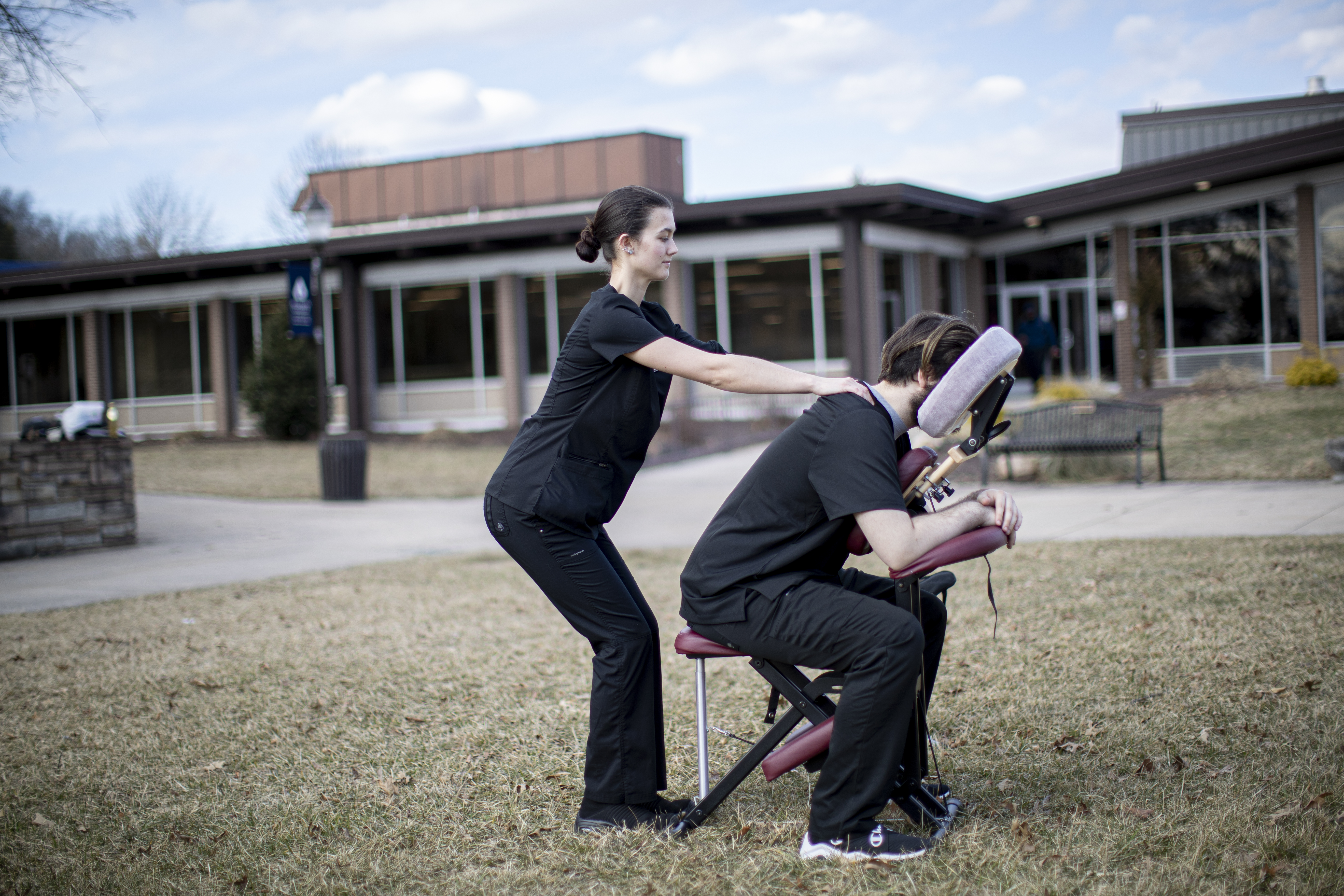 Student massaging in an outdoor class