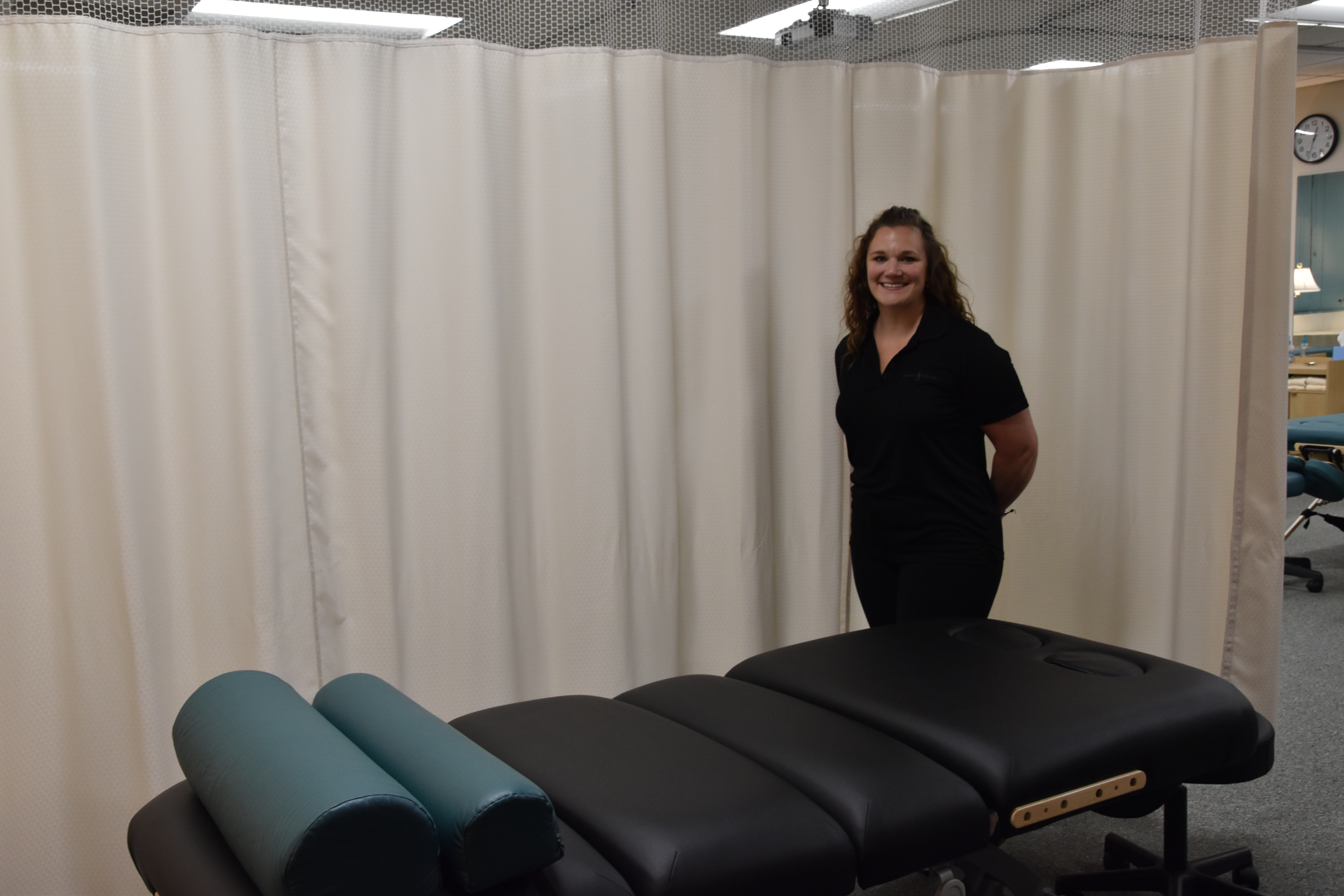 Massage Student standing by massage bed