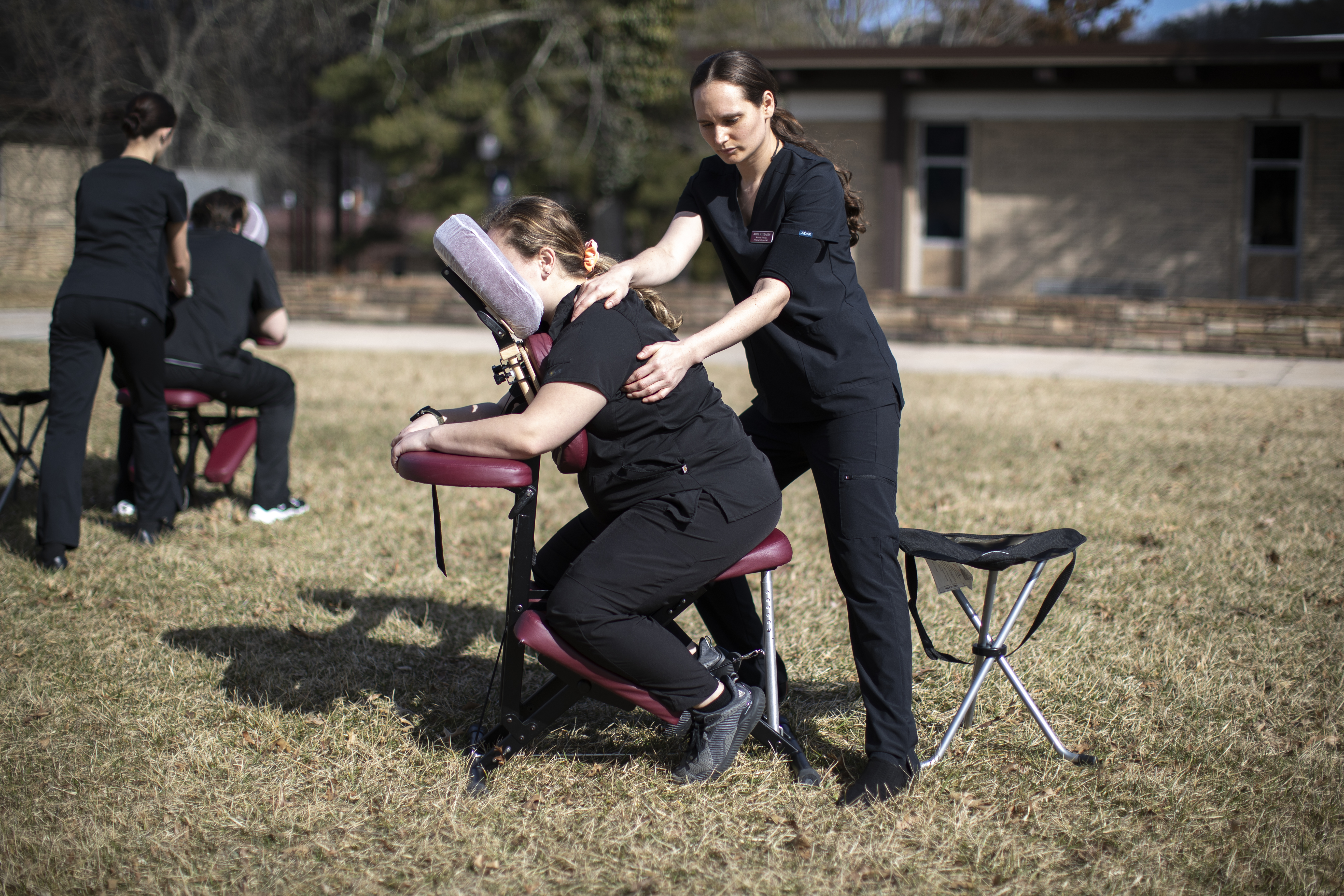 Student massaging in an outdoor class