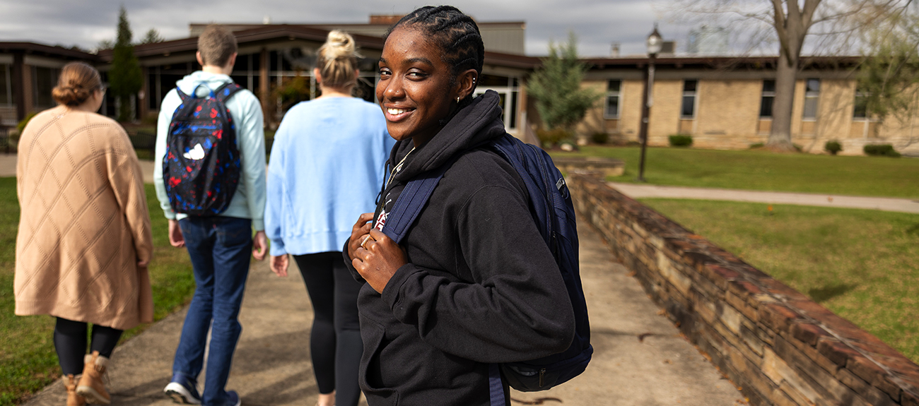 Student looking back at the camera as students walk by