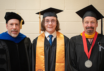 Instructors and Student at Graduation Ceremony