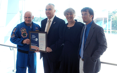 Astronaut Scott Kelly holds the Silver Snoopy Award with Dr. Knight & family