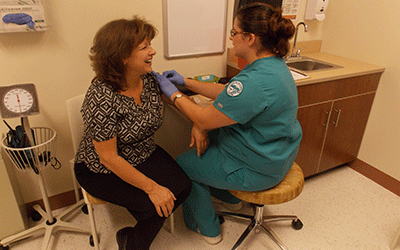 Nursing student administers flu shot
