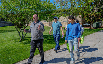 Guide leads campus tour for a family of three.