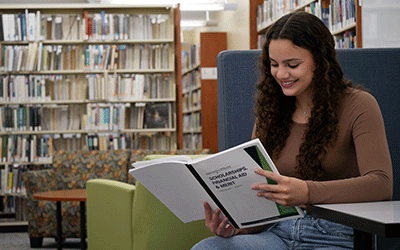ACM student Ariaya reads the Scholarships Catalog