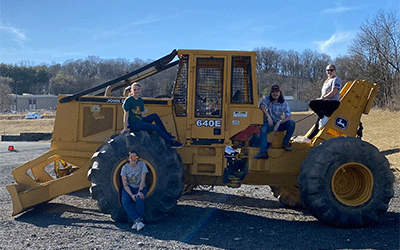 ACM forestry students with skidder