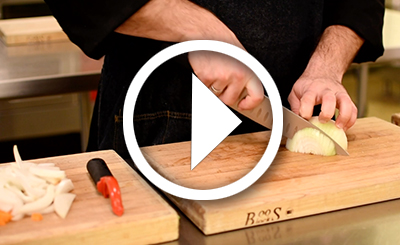 Adam Kenney cutting an onion