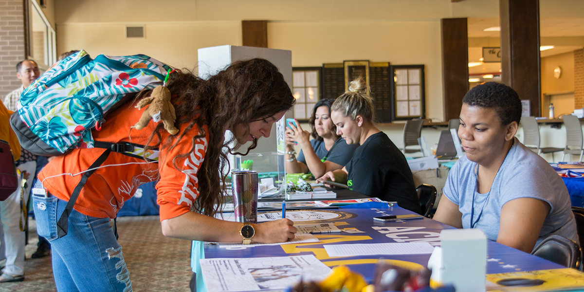 Student signing up for a club