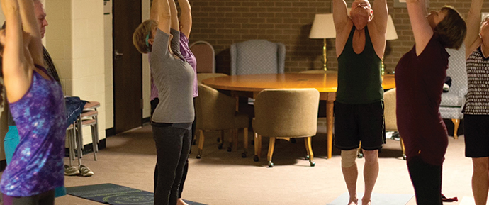 Group of people involed in a yoga class